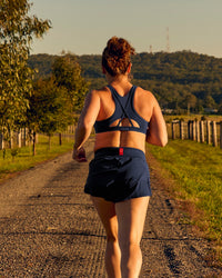 Woman wearing Unstoppable Racerback Sports Bra - Future Navy | Model:Tia | Size:M | Thumbnail Index: 4
