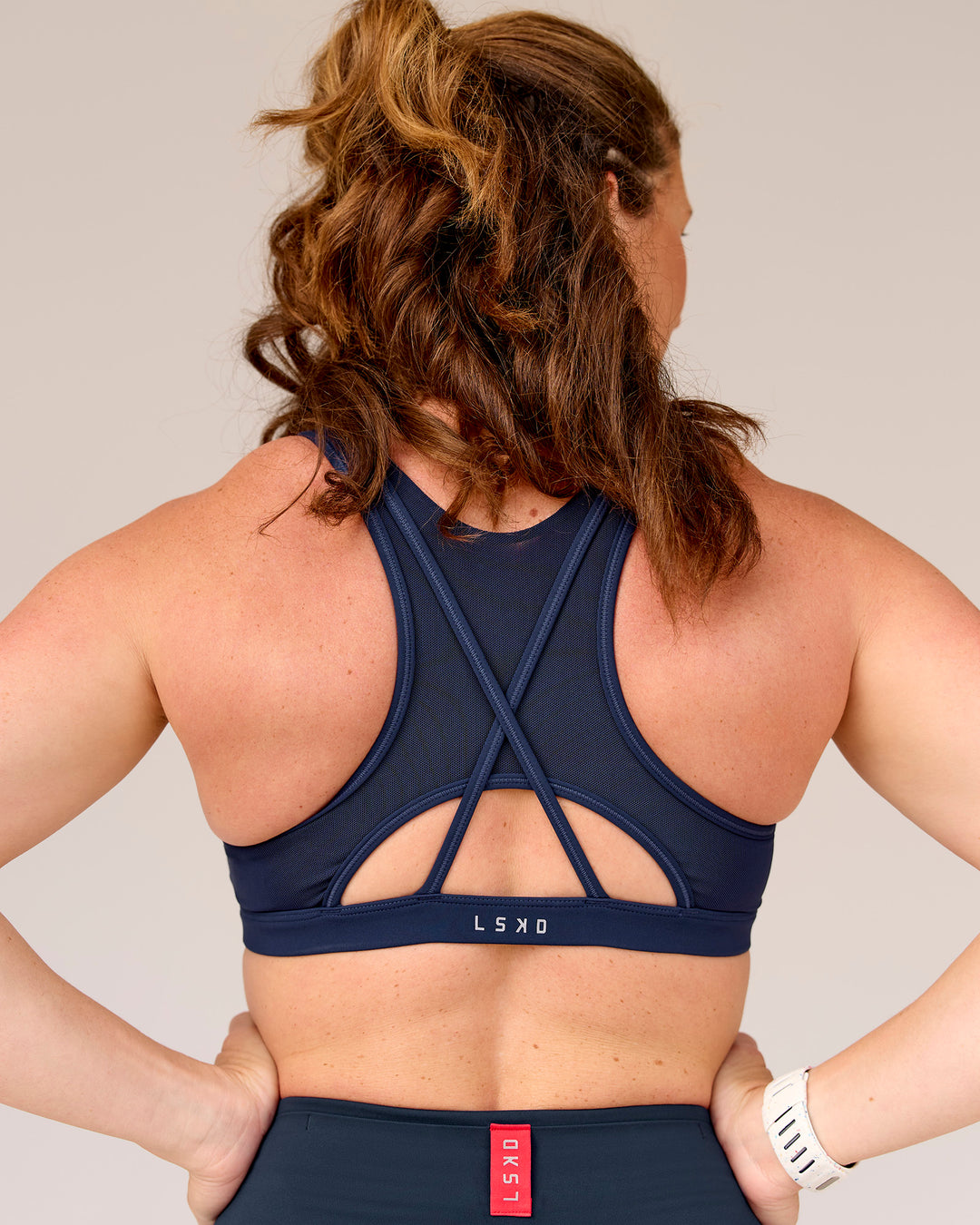 Woman wearing Unstoppable Racerback Sports Bra - Future Navy | Model:Tia | Size:M - view 3