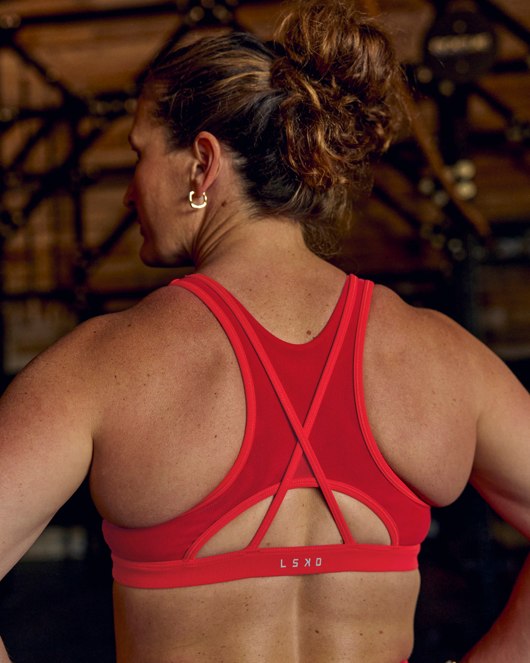 Woman wearing Unstoppable Racerback Sports Bra - Scarlet | Model:Tia | Size:M - view 7