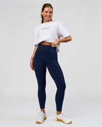 Woman wearing O.G. Fusion Ultra High-Rise Full Length Legging Pockets - Future Navy | Model:Amity| Size:S | Thumbnail Index: 0