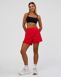 Woman wearing Challenger 5" Lined Performance Short - Scarlet | Model:Amity | Size:S