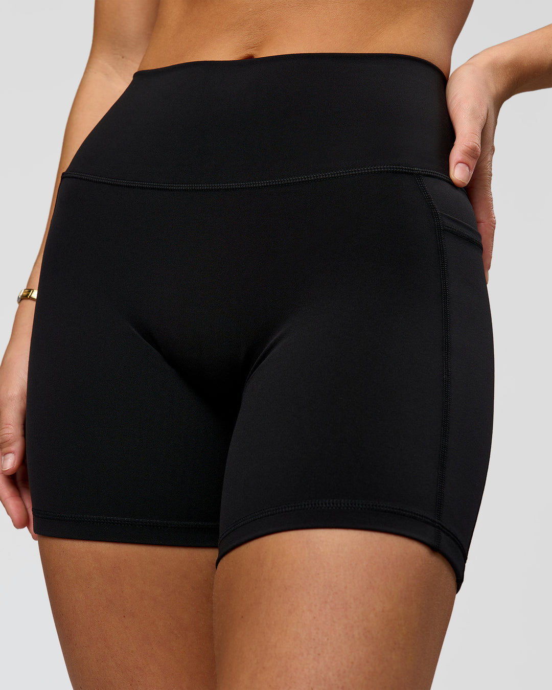 Woman wearing O.G. Fusion High-Rise 6" Short Pockets - Black | Model:Amity | Size:S - view 1