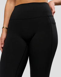 Woman wearing O.G. Fusion High-Rise Full Length Legging Pockets - Black | Model:Amity | Size:S | Thumbnail Index: 9