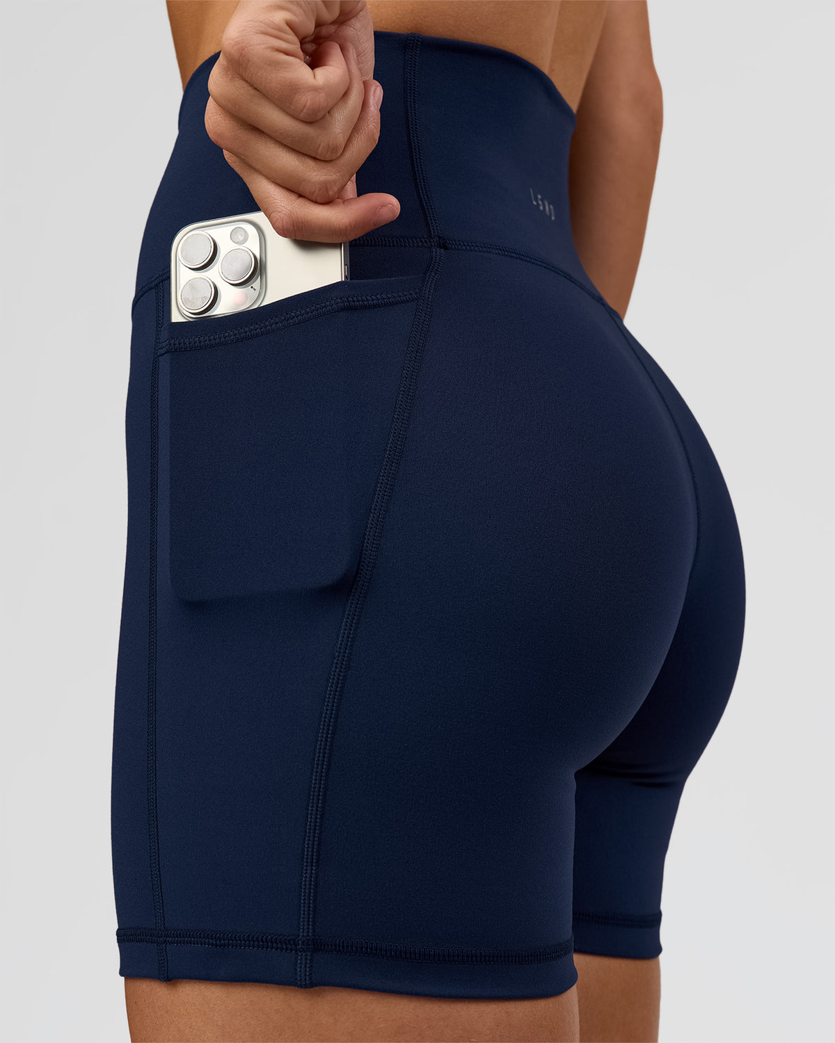 Woman wearing O.G. Fusion Ultra High-Rise 6" Short Pockets - Future Navy | Model:Amity | Size:S - view 1