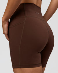 Woman wearing O.G. Fusion Ultra High-Rise 6" Short Pockets - Hot Chocolate | Model:Amity | Size:S | Thumbnail Index: 1