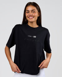 Woman wearing Deadly Runners Run Club FLXCotton Oversize Tee - Black | Model:Bella | Size:S | Thumbnail Index: 3