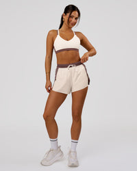 Woman wearing Accelerate 3" Force High-Rise Running Short - Cocoa Powder-Off White | Model:Bianca | Size:S | Thumbnail Index: 3