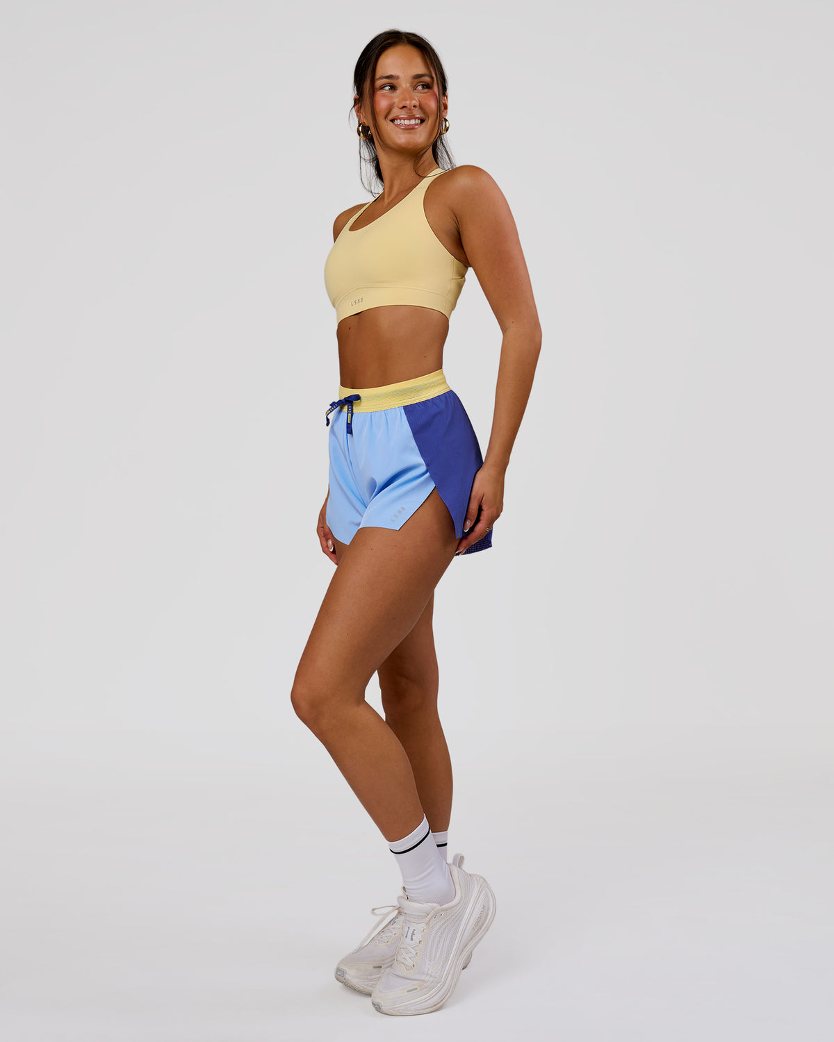 Woman wearing Accelerate 3" High-Rise Running Short - Power Cobalt-Open Air-Lemon | Model:Bianca | Size:S - view 2