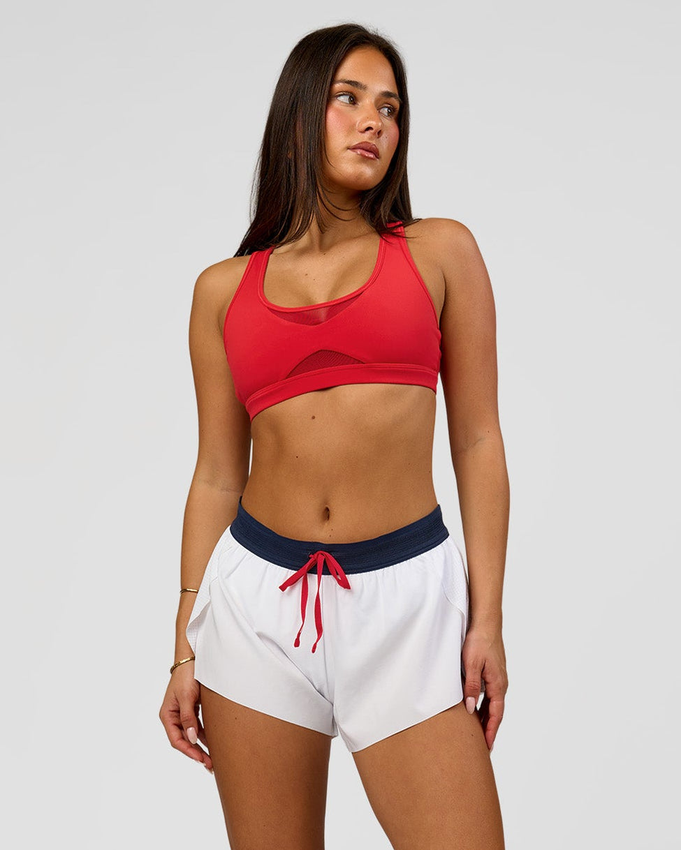 Woman wearing Accelerate 3" Mid-Rise Running Short - White-Future Navy | Model:Bianca | Size:S