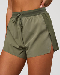 Woman wearing Accelerate 3" High-Rise Running Short - Pure Olive-Fog | Model:Bianca | Size:S | Thumbnail Index: 0