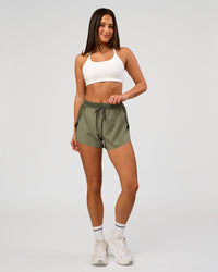 Woman wearing Accelerate 3" High-Rise Running Short - Pure Olive-Fog | Model:Bianca | Size:S | Thumbnail Index: 2
