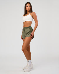 Woman wearing Accelerate 3" High-Rise Running Short - Pure Olive-Fog | Model:Bianca | Size:S | Thumbnail Index: 4