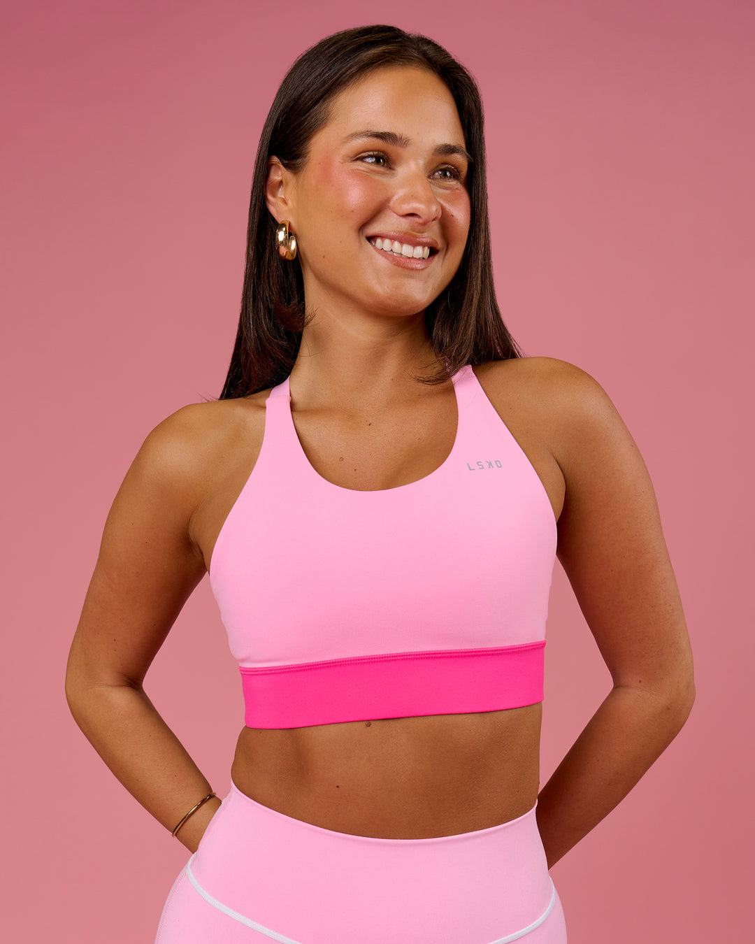 Woman wearing Accelerate Split Strap Sports Bra - Pink Rose-Ultra Pink | Model:Bianca | Size:S - view 1