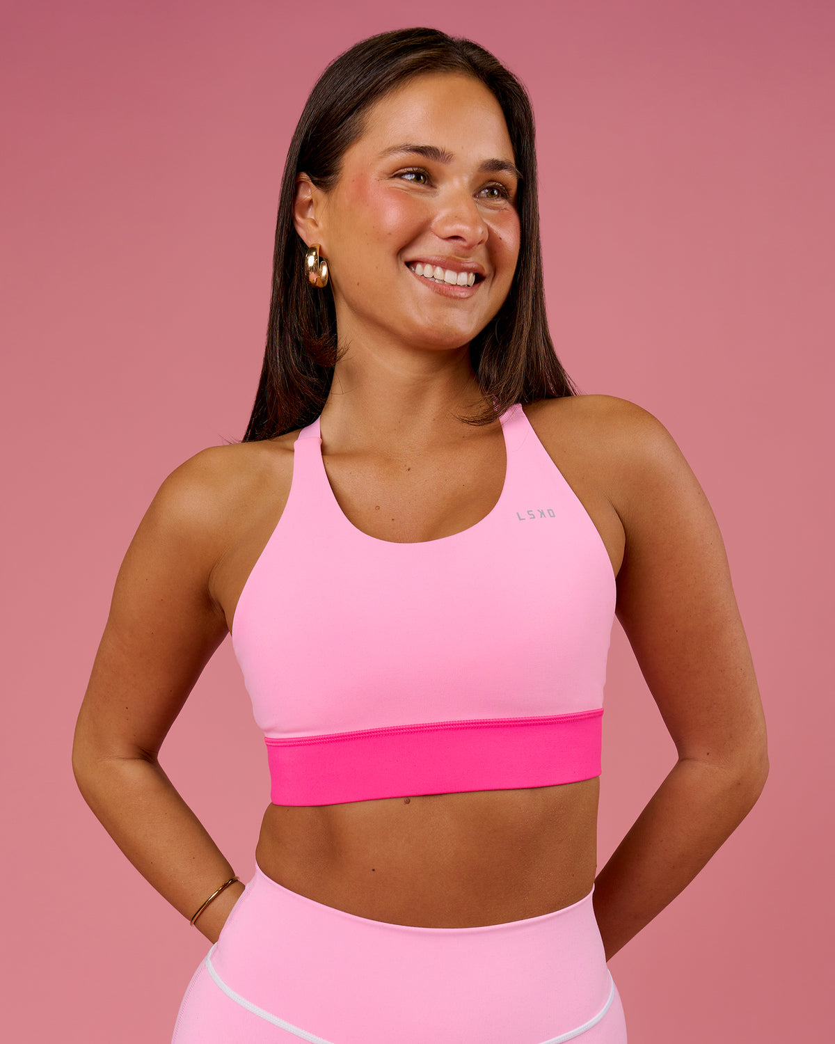 Woman wearing Accelerate Split Strap Sports Bra - Pink Rose-Ultra Pink | Model:Bianca | Size:S