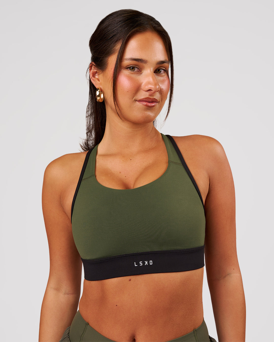 Woman wearing Distinction Sports Bra 2.0 - Pure Olive-Black | Model:Bianca | Size:S - view 1