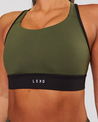 Woman wearing Distinction Sports Bra 2.0 - Pure Olive-Black | Model:Bianca | Size:S | Thumbnail Index: 1
