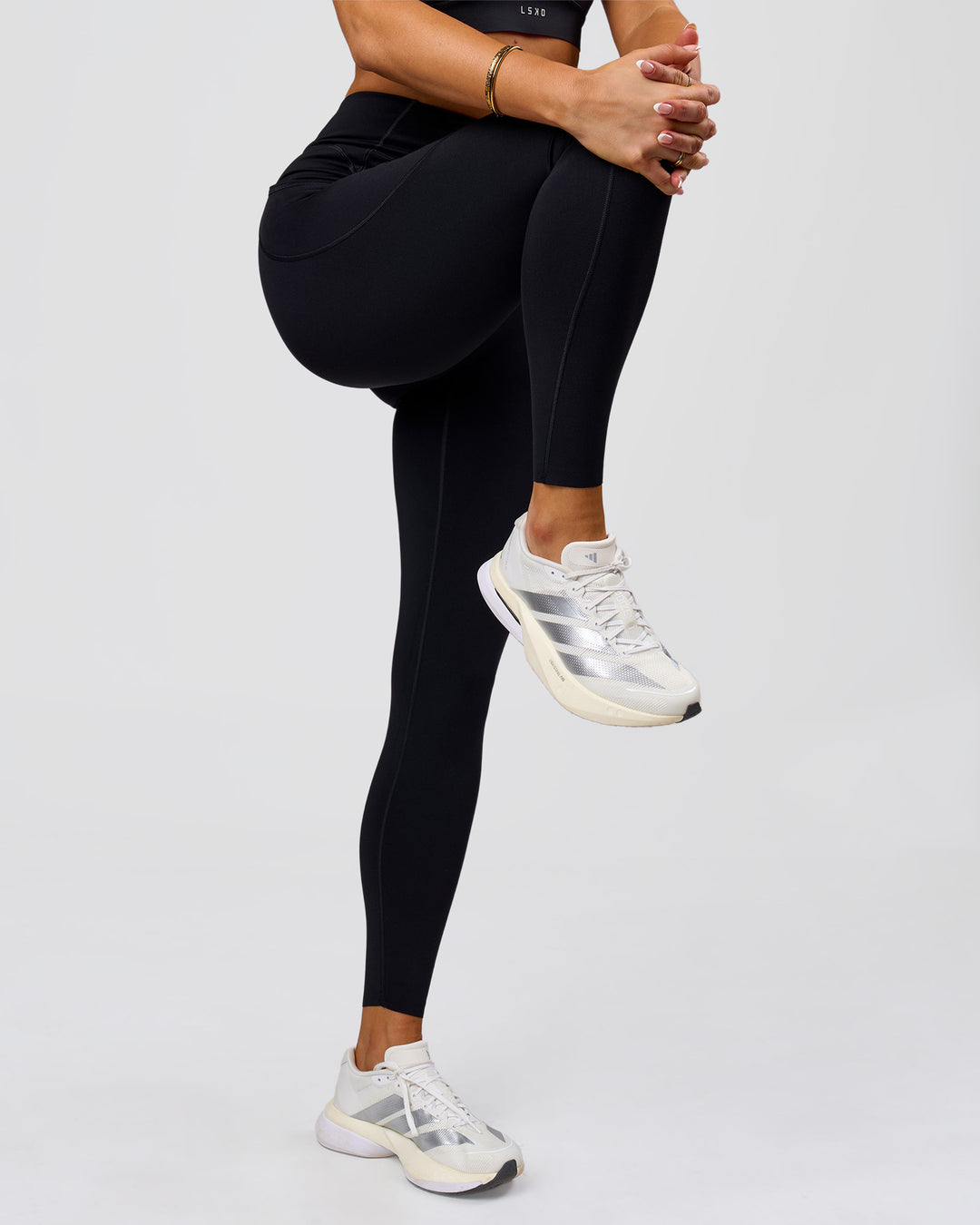 Woman wearing Elite Run High-Rise Full Length Legging Pockets - Black | Model:Bianca | Size:S - view 2