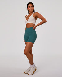 Woman wearing Elixir High-Rise 6” Short - Transformative Teal | Model:Bianca | Size:S | Thumbnail Index: 6