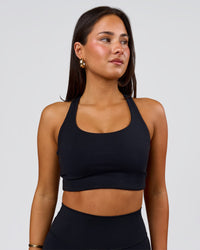 Woman wearing Flow Long Line Sports Bra - Black | Model:Bianca | Size:S | Thumbnail Index: 1