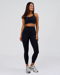 Woman wearing Flow Long Line Sports Bra - Black | Model:Bianca | Size:S | Thumbnail Index: 4