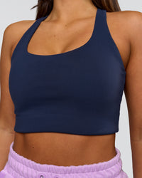 Woman wearing Flow Long Line Sports Bra - Future Navy | Model:Bianca | Size:S | Thumbnail Index: 0