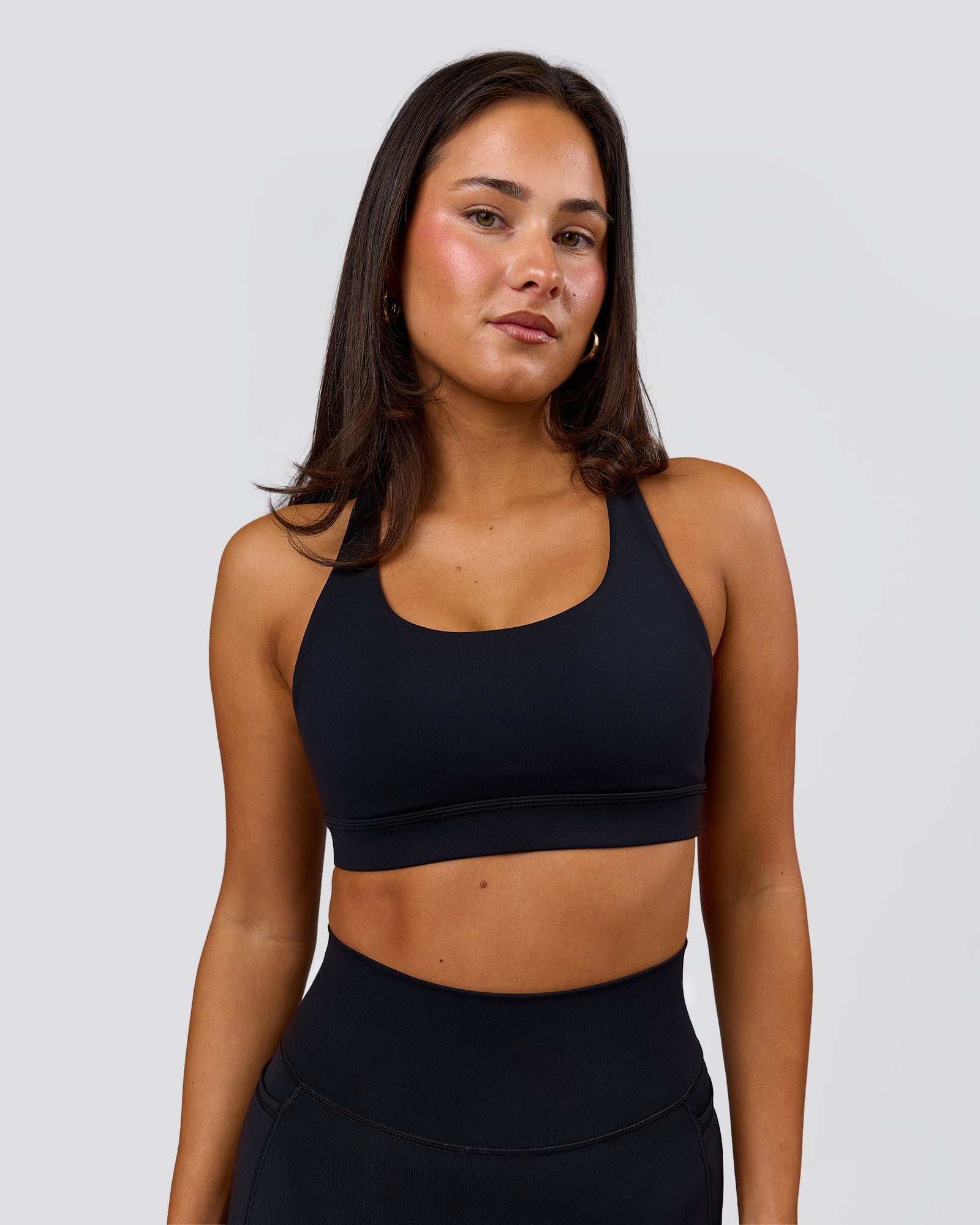 Woman wearing Flow Sports Bra - Black | Model:Bianca | Size:S