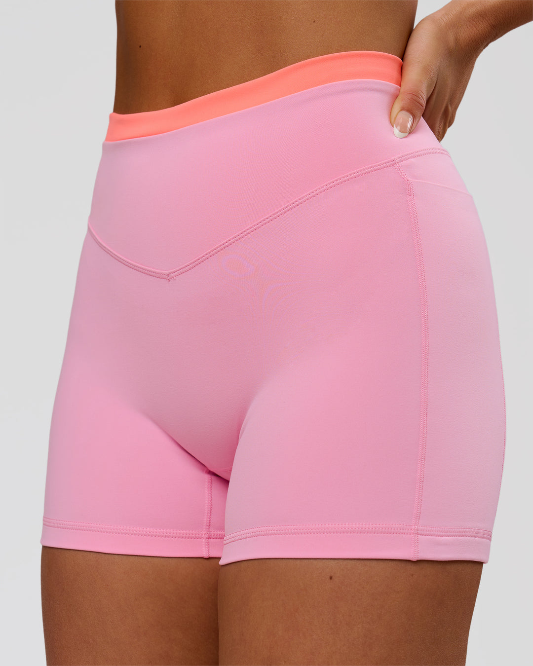 Woman wearing Fusion Contrast V-Waist High-Rise 4" Short Pockets - Pink Rose-Hyper Orange | Model:Bianca | Size:S - view 1