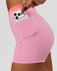 Woman wearing Fusion Contrast V-Waist High-Rise 4" Short Pockets - Pink Rose-Hyper Orange | Model:Bianca | Size:S | Thumbnail Index: 2