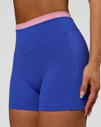 Woman wearing Fusion Contrast V-Waist High-Rise 4" Short Pockets - Power Cobalt-Pink Rose | Model:Bianca | Size:S | Thumbnail Index: 0