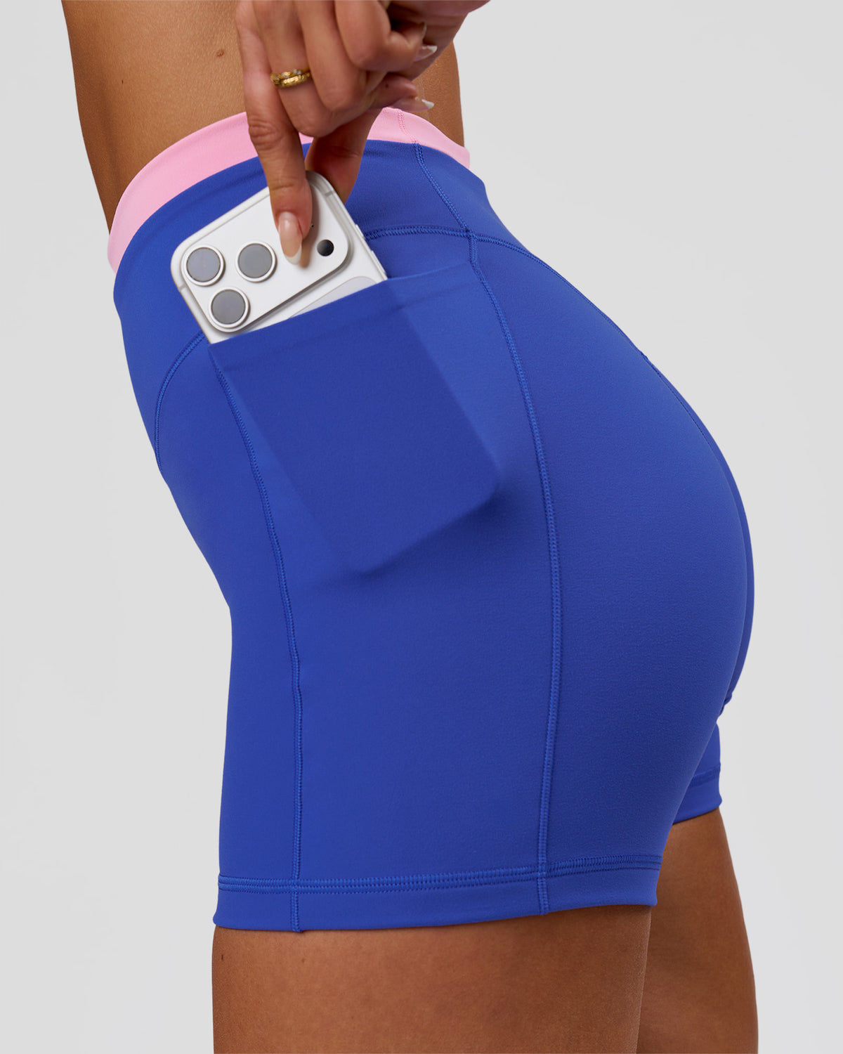Woman wearing Fusion Contrast V-Waist High-Rise 4" Short Pockets - Power Cobalt-Pink Rose | Model:Bianca | Size:S - view 2