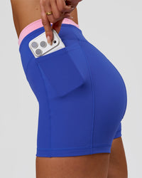 Woman wearing Fusion Contrast V-Waist High-Rise 4" Short Pockets - Power Cobalt-Pink Rose | Model:Bianca | Size:S | Thumbnail Index: 1