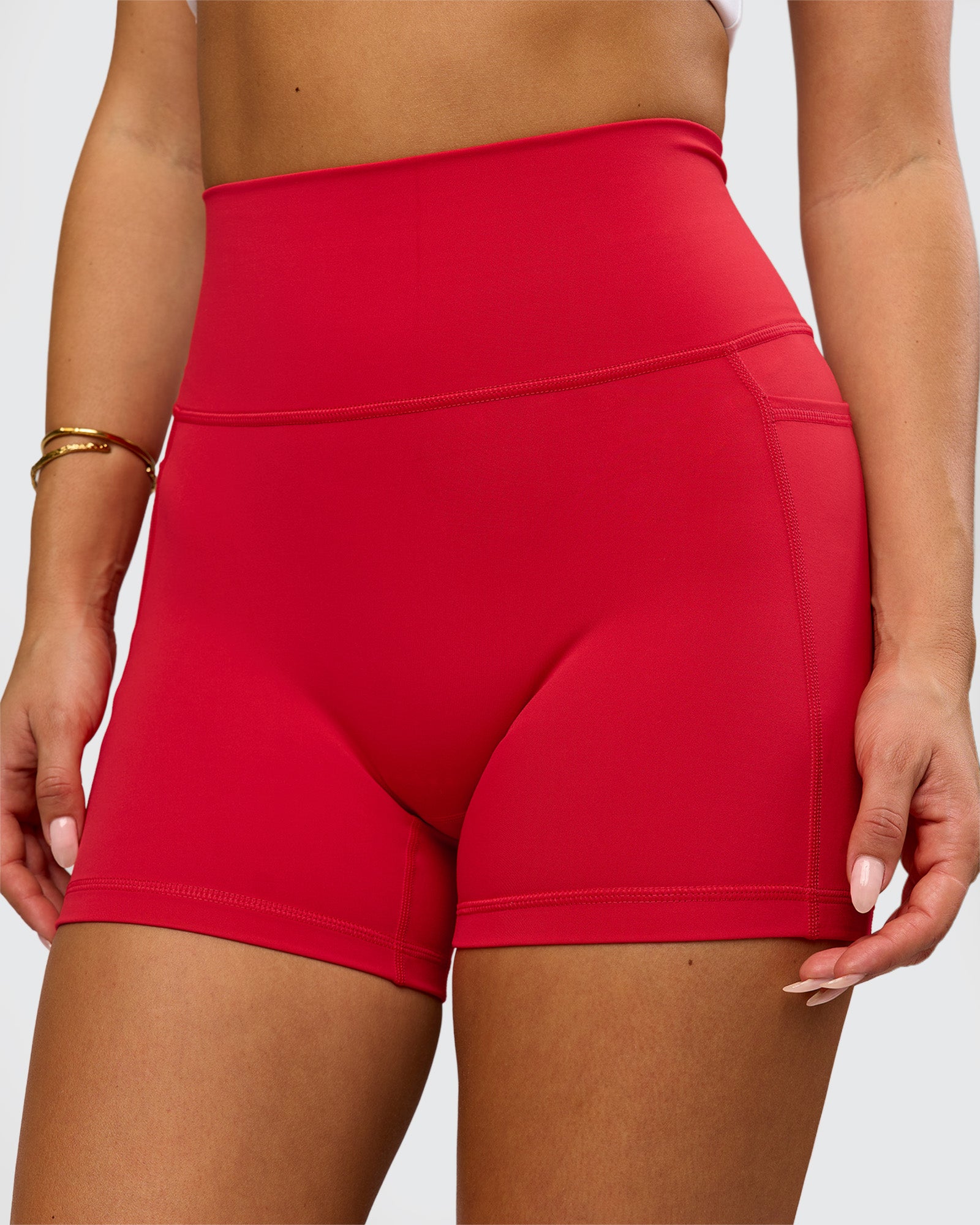 Woman wearing Fusion Ultra High-Rise 4" Short Pockets - Scarlet | Model:Bianca | Size:S