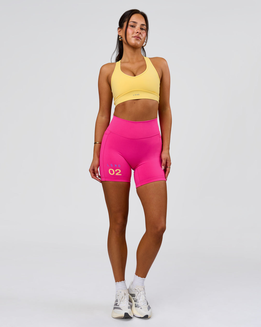 Woman wearing Fusion V-Contour High-Rise 6" Short Pockets - Ultra Pink-Tech Department | Model:Bianca | Size:S - view 5