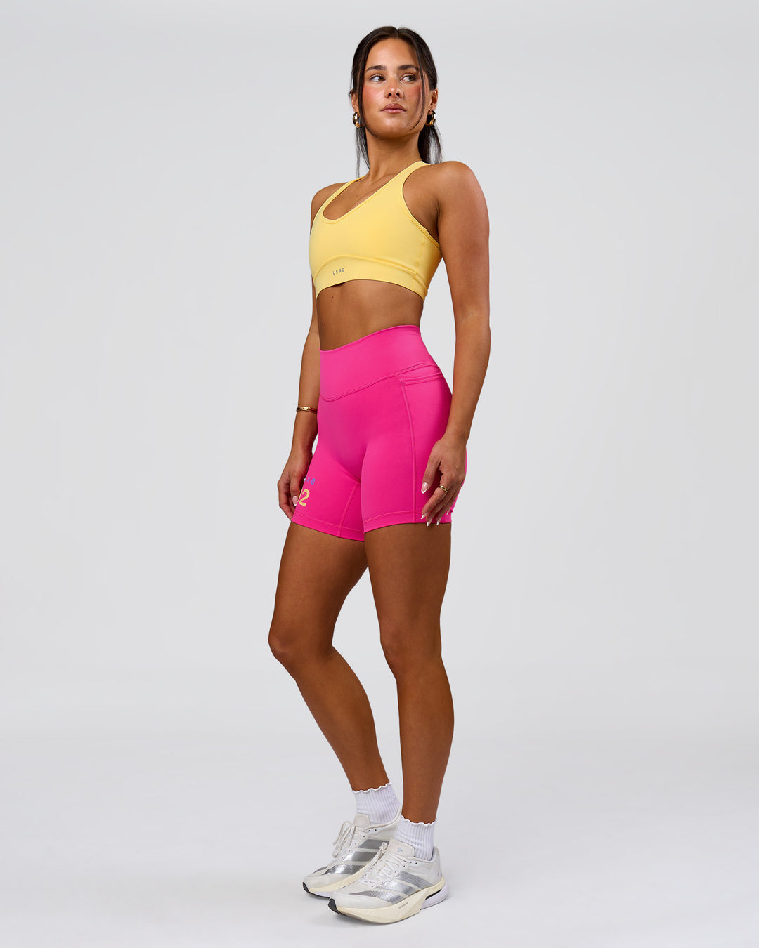 Woman wearing Fusion V-Contour High-Rise 6" Short Pockets - Ultra Pink-Tech Department | Model:Bianca | Size:S - view 6