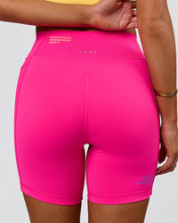 Woman wearing Fusion V-Contour High-Rise 6" Short Pockets - Ultra Pink-Tech Department | Model:Bianca | Size:S | Thumbnail Index: 9