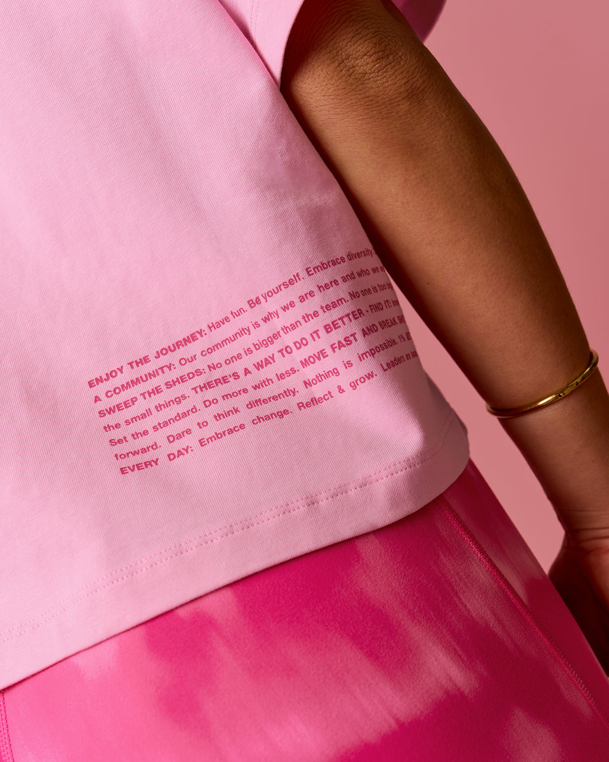 Woman wearing Go-To Heavyweight FLXCotton Graphic Skimmer Tee - Pink Rose-We Rise | Model:Bianca | Size:S