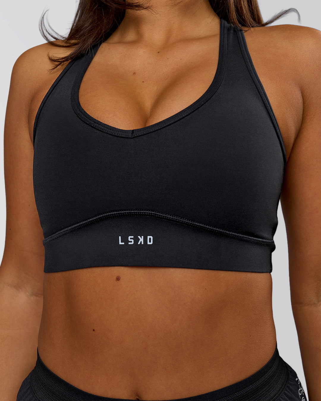 Woman wearing Stamina Amplify Sports Bra - Black | Model:Bianca | Size:S - view 1