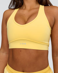 Woman wearing Stamina Amplify Sports Bra - Lemon | Model:Bianca | Size:S | Thumbnail Index: 0