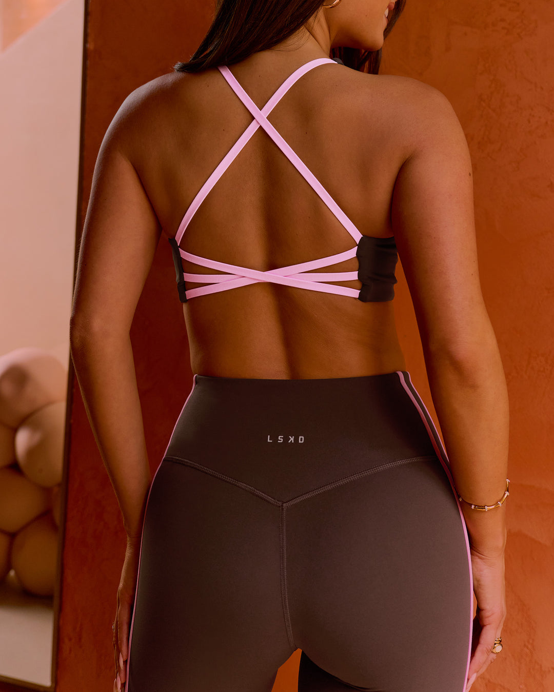 Woman wearing Stellar Sports Bra - Hot Chocolate-Pink Rose | Model:Bianca | Size:S - view 1