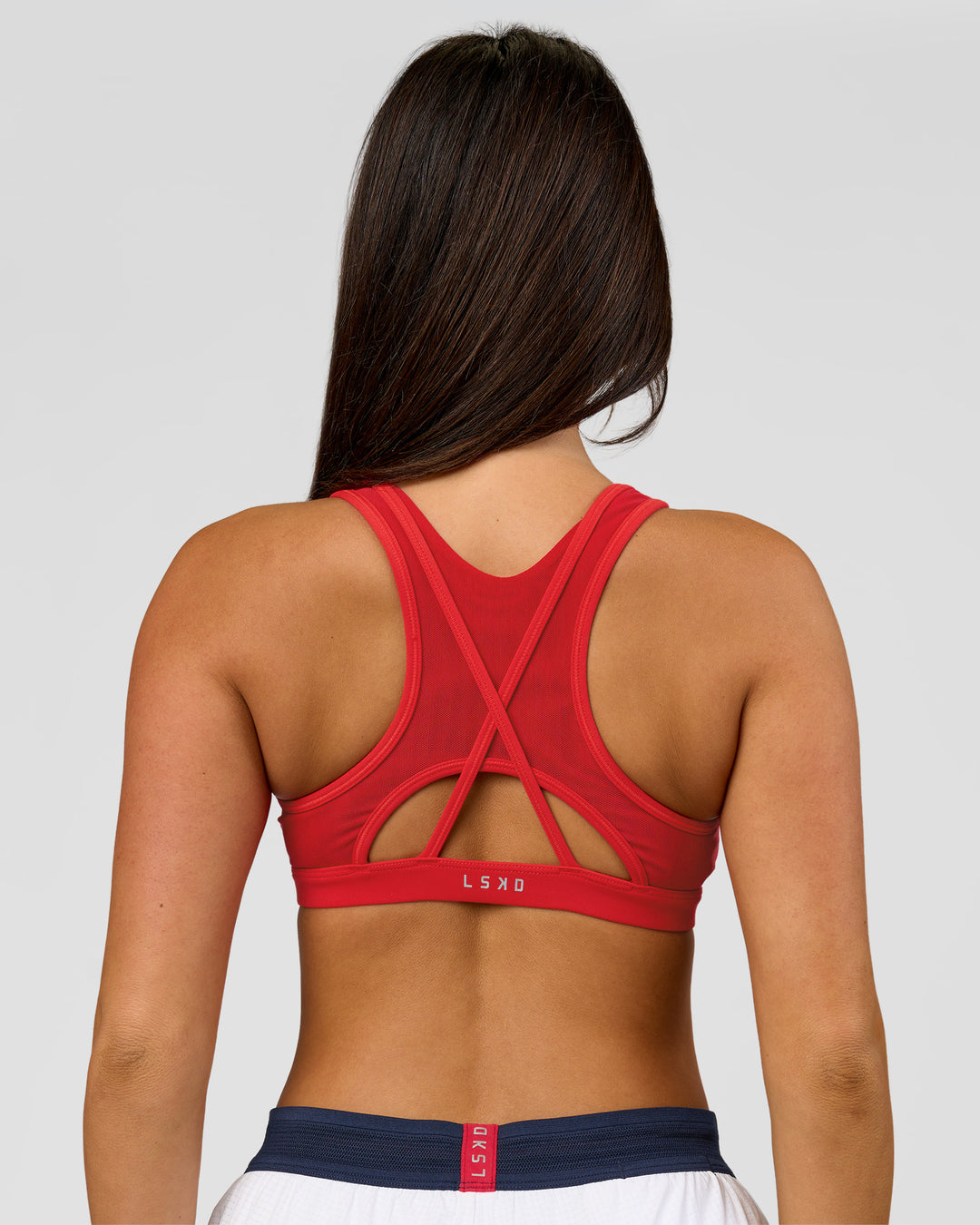 Woman wearing Unstoppable Racerback Sports Bra - Scarlet | Model:Bianca | Size:S - view 13