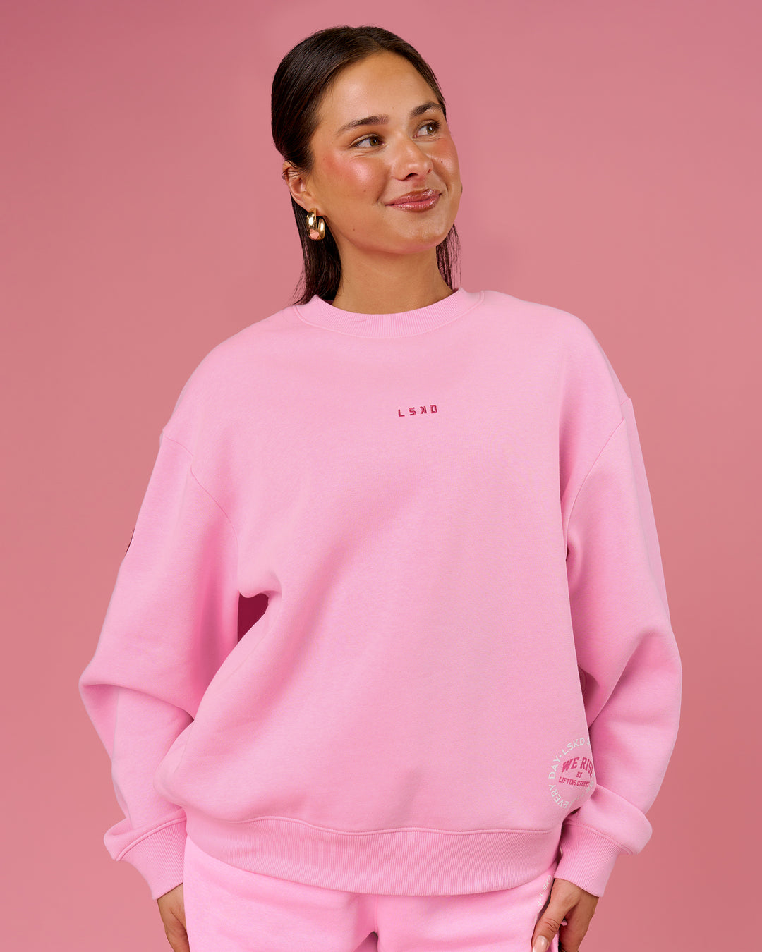 Woman wearing We Rise Oversized Sweater - Pink Rose-We Rise | Model:Bianca | Size:S - view 1