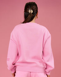 Woman wearing We Rise Oversized Sweater - Pink Rose-We Rise | Model:Bianca | Size:S | Thumbnail Index: 1