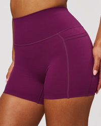 Woman wearing Elixir High-Rise 4" Short Pockets - Plum Caspia | Model:Jordan | Size:S | Thumbnail Index: 0