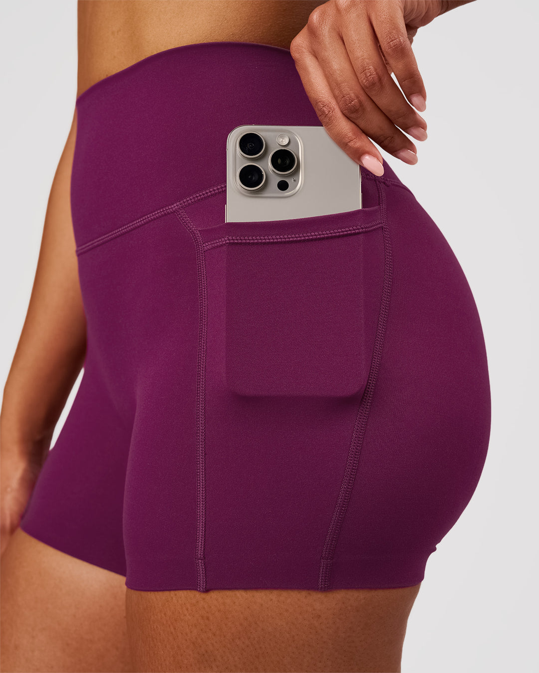 Woman wearing Elixir High-Rise 4" Short Pockets - Plum Caspia | Model:Jordan | Size:S - view 3