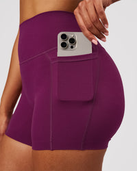 Woman wearing Elixir High-Rise 4" Short Pockets - Plum Caspia | Model:Jordan | Size:S | Thumbnail Index: 2