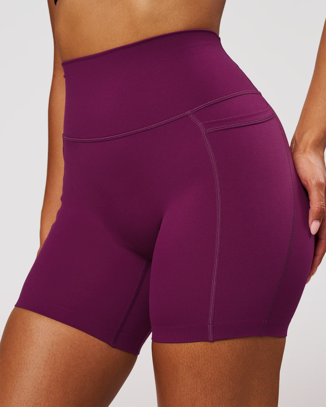 Woman wearing Elixir High-Rise 6" Short Pockets - Plum Caspia | Model:Jordan | Size:S - view 1