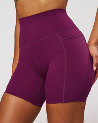 Woman wearing Elixir High-Rise 6" Short Pockets - Plum Caspia | Model:Jordan | Size:S | Thumbnail Index: 0