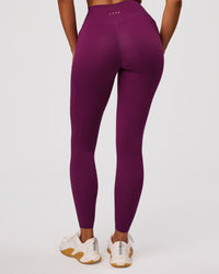 Woman wearing Elixir High-Rise Full Length Legging Pockets - Plum Caspia | Model:Jordan | Size:S | Thumbnail Index: 1