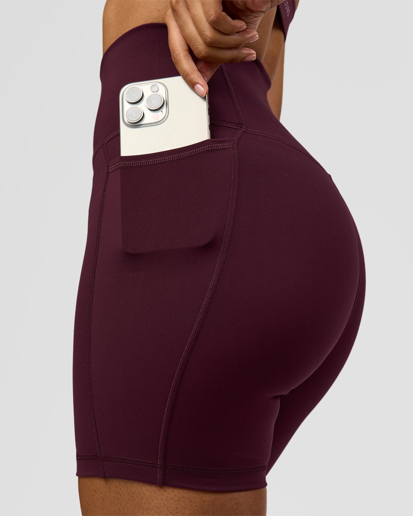 Woman wearing Fusion Ultra High-Rise 6" Short Pockets - Cherry Lacquer | Model:Jordan | Size:S