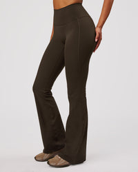 Woman wearing Fusion V-Contour High-Rise Flared Legging Pockets - Ground Coffee | Model:Jordan | Size:S | Thumbnail Index: 0